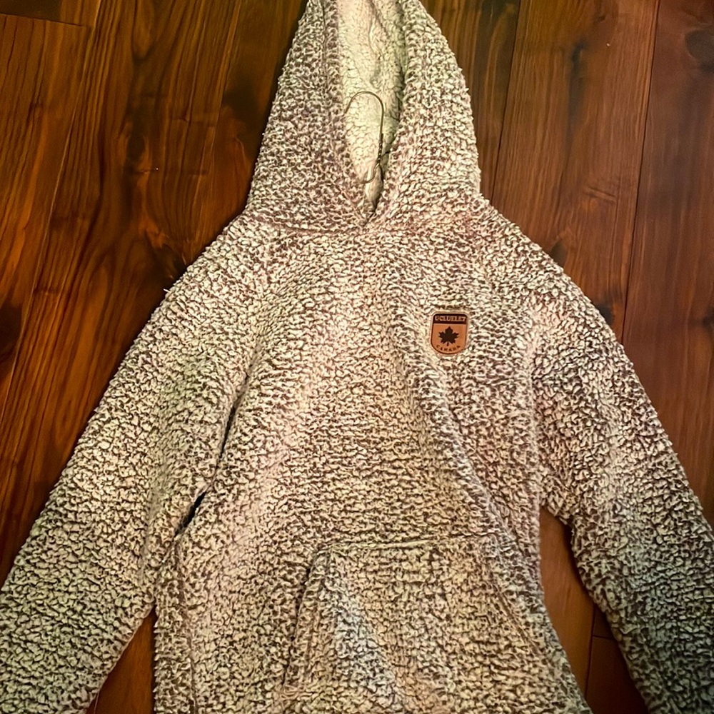 A warm fluffy sweater. It says size small but fits medium.
